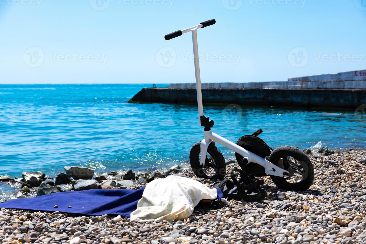 Sports bike in white, the scooter is parked on the beach. Selective focus. photo