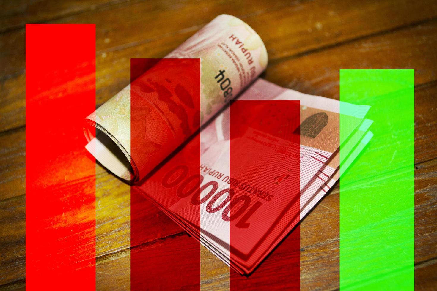 A red and green bar chart with a roll of one hundred thousand rupiah photo