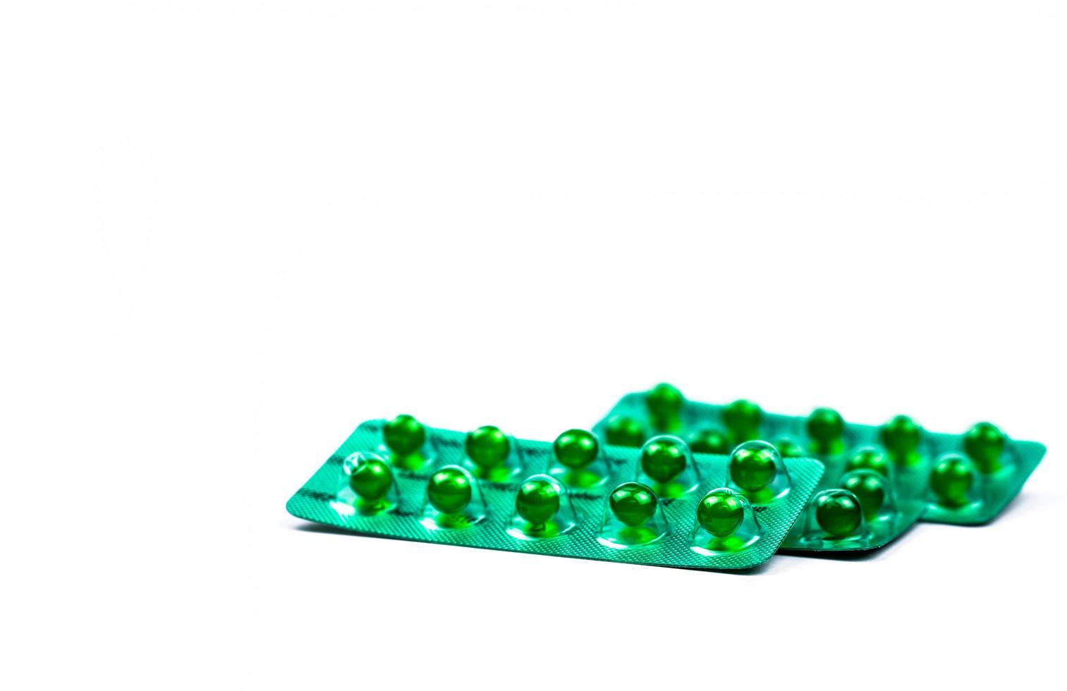 Green round soft capsule pills isolated on white background with copy space. Ayurvedic medicine for indigestion, gas and acidity. Herbal medicine made from Mentha oil and spearmint oil from India photo