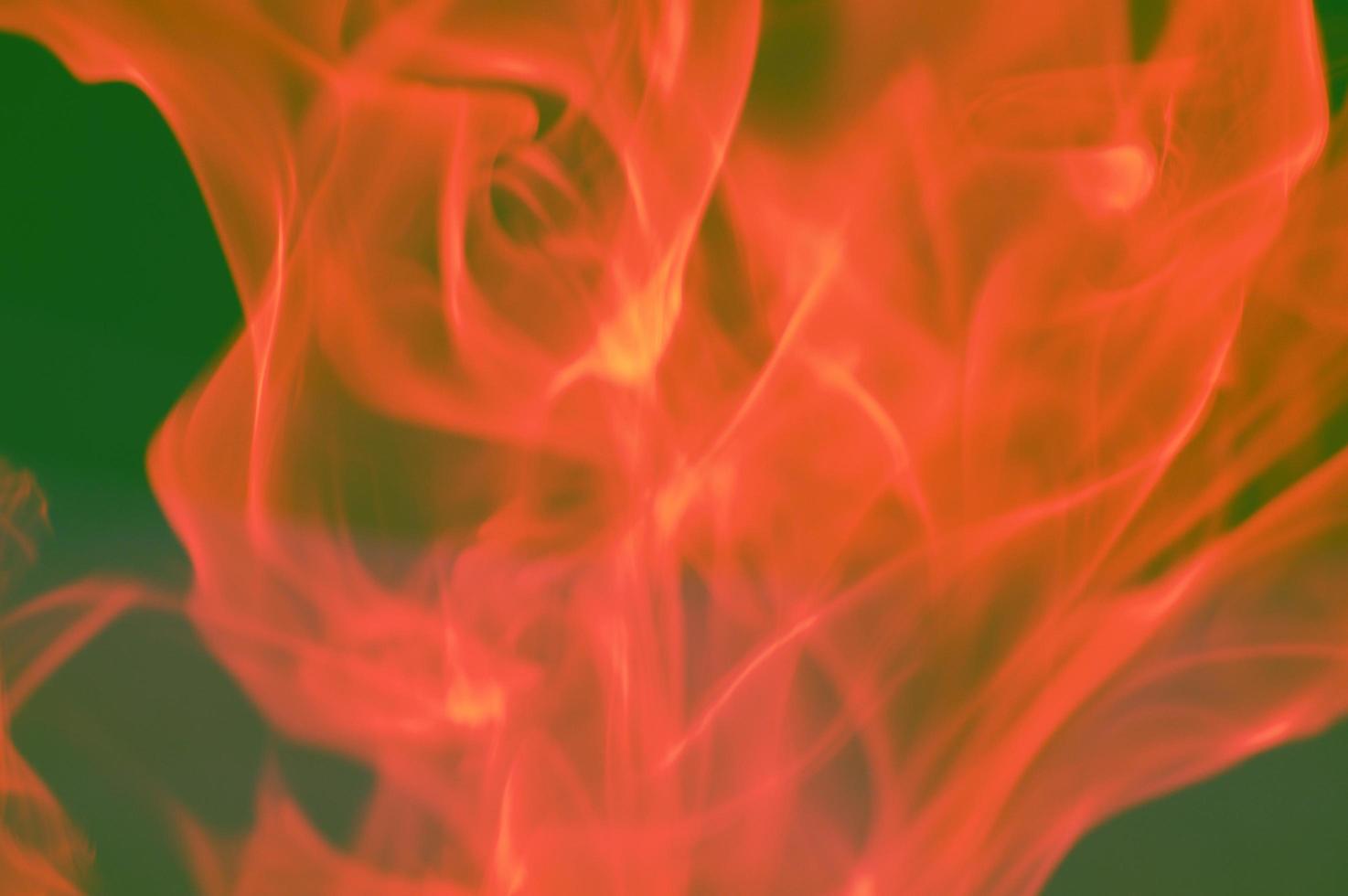 Abstract red orange smoke on a dark background, flames. Fire design and the concept of darkness, burning. photo
