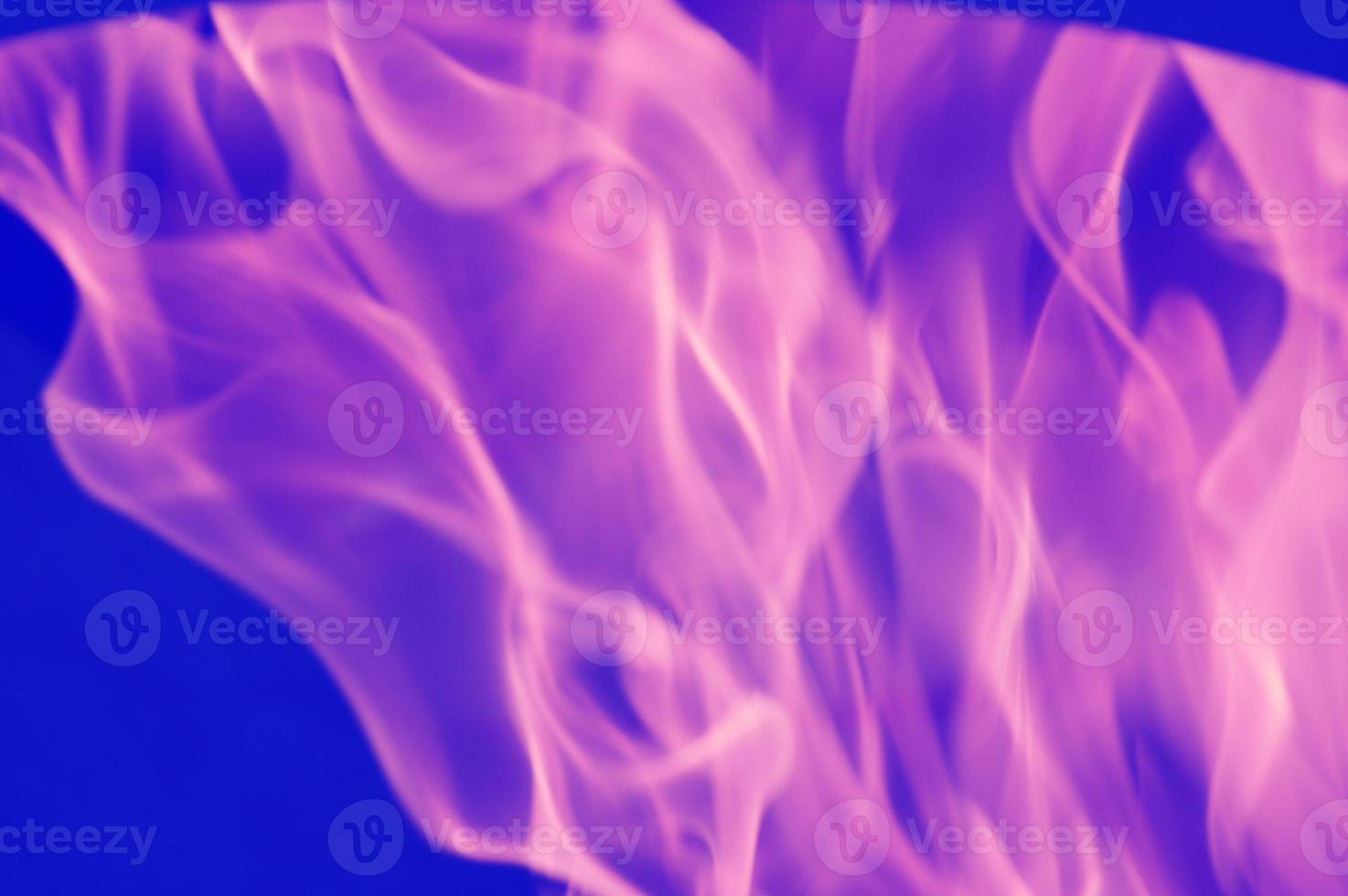 Abstract pink-violet reflections of light, flame, smoke, blurred on a blue background. Bright colored background. photo