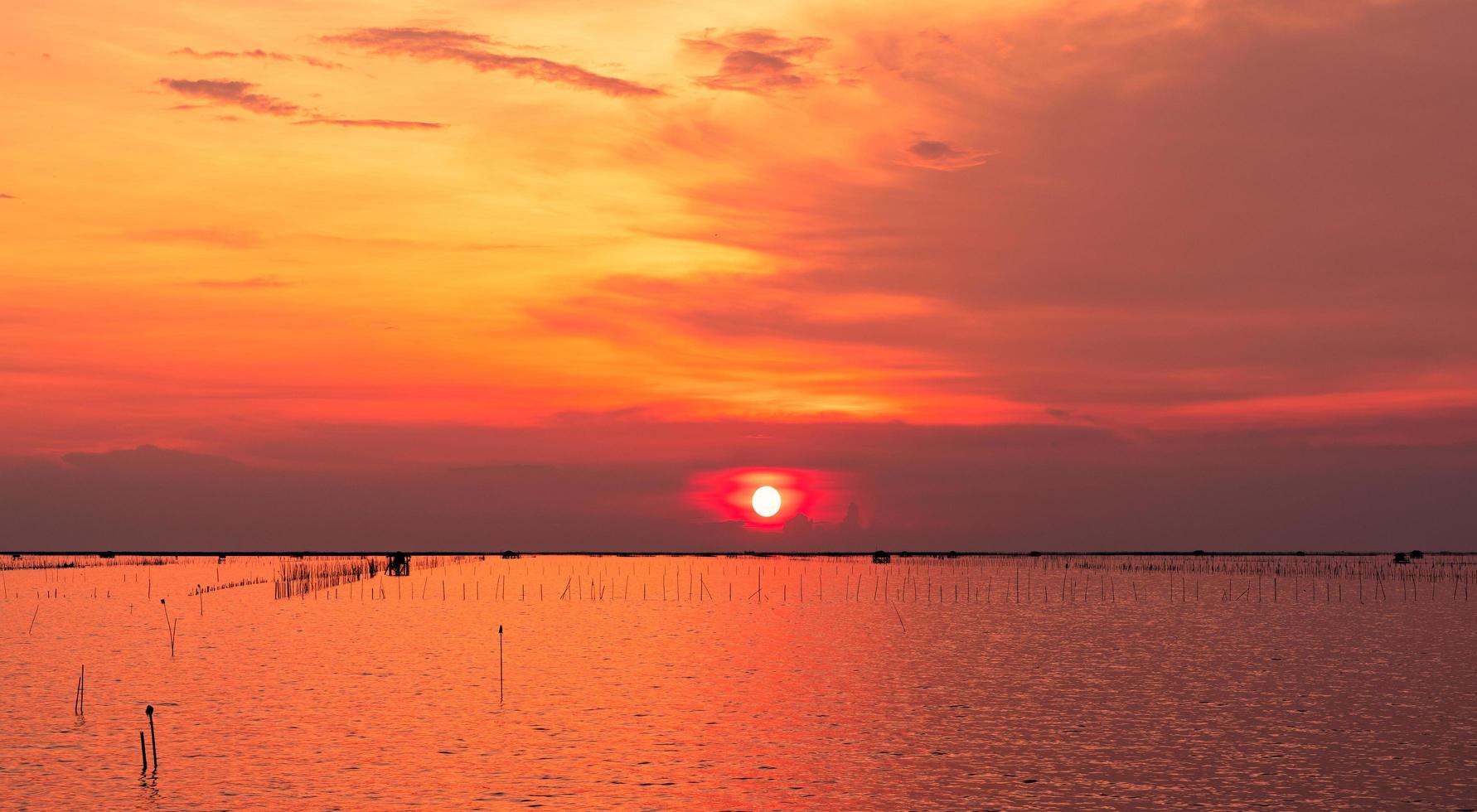 Beautiful sunset sky. Beach sunset. Twilight sea and sky. Tropical sea at dusk. Dramatic orange and golden sky. Calm sea. Sunset abstract background. Golden sky in the evening. Calm and relax life. photo