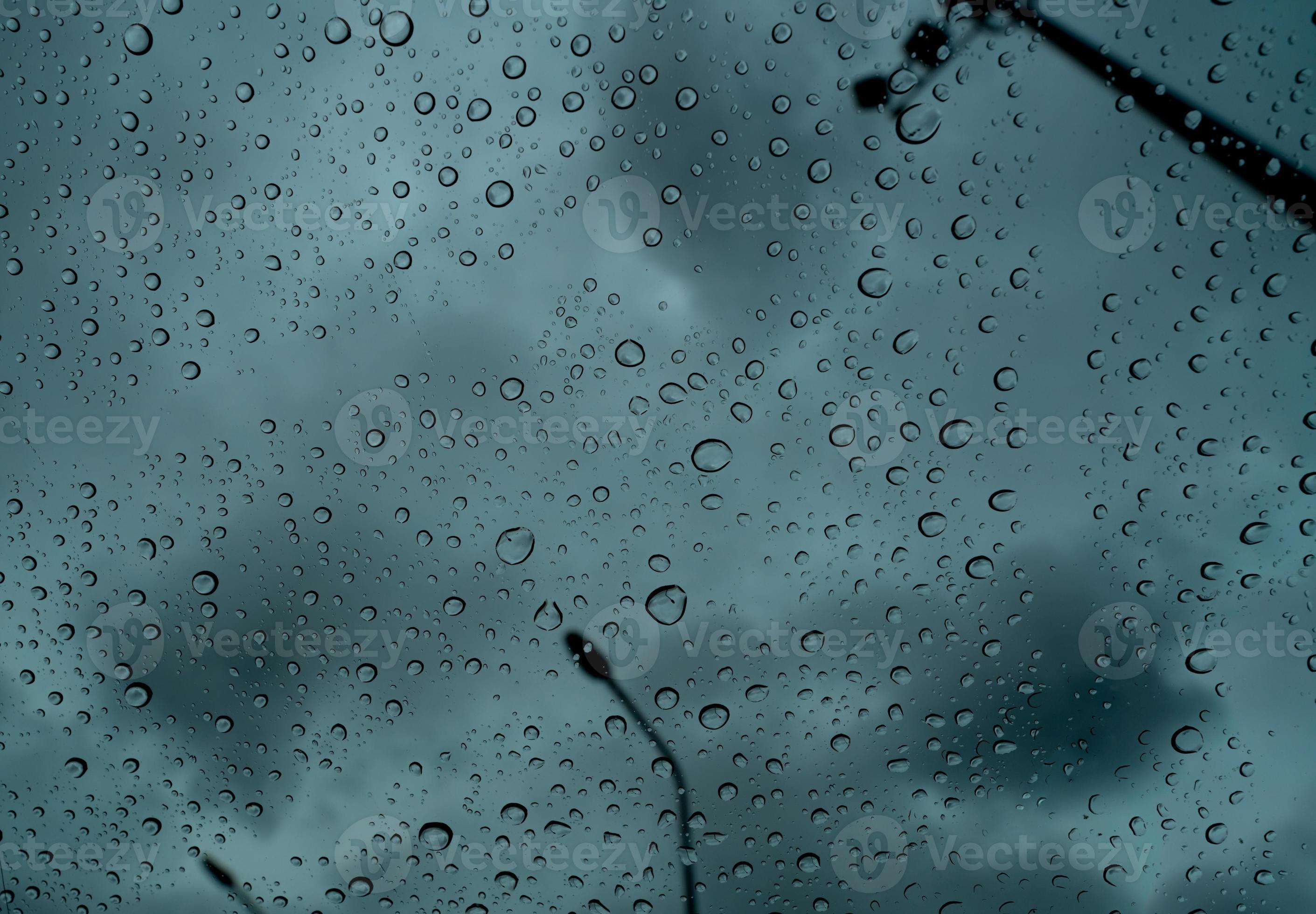 Raindrops on transparent glass against blur dark stormy sky and electric  pole. Rain drops on windshield. Windshield window of car with raindrops.  Storm day. Sad and depressed abstract background. 8820219 Stock Photo