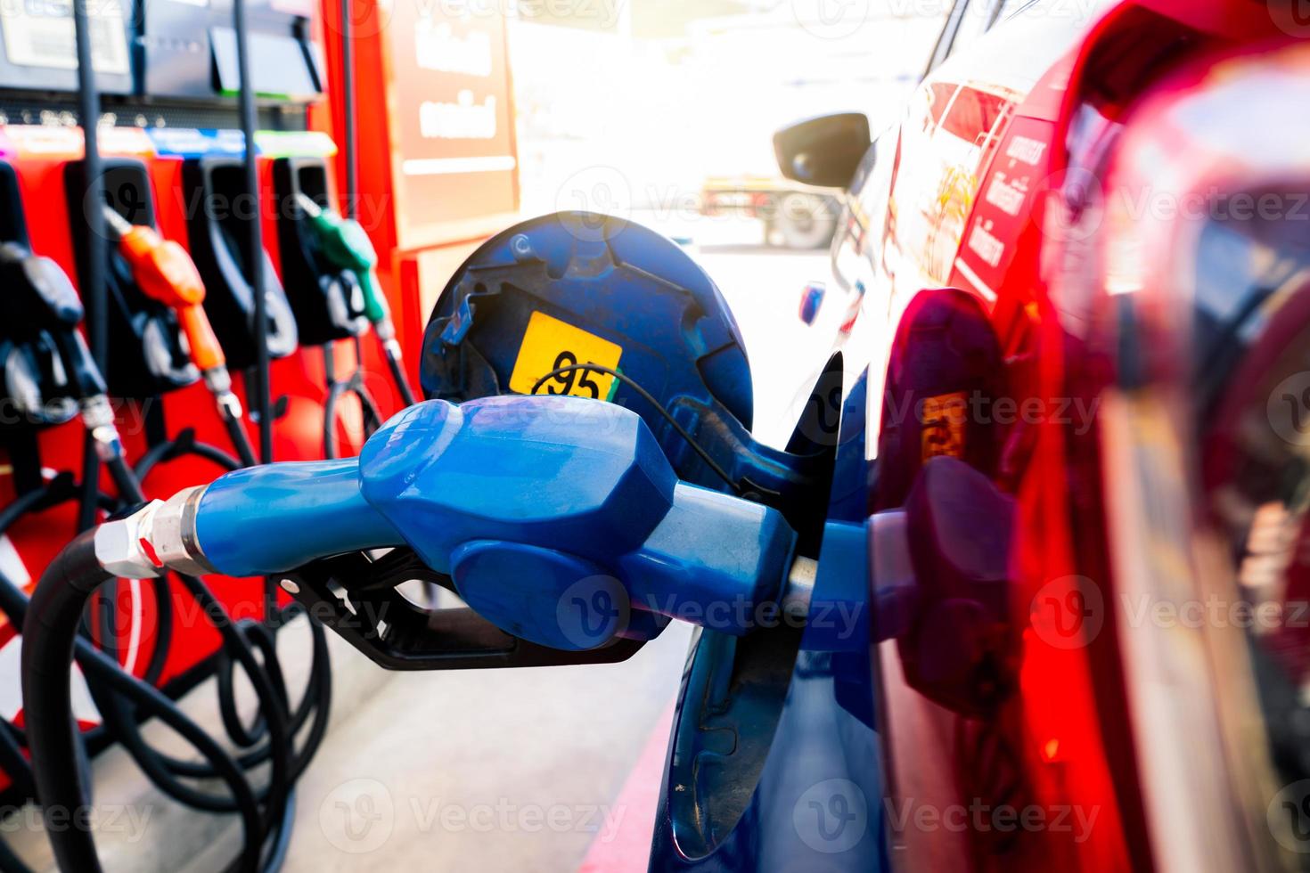 Car fueling at gas station. Refuel fill up with petrol gasoline. Petrol pump filling fuel nozzle in fuel tank of car at gas station. Petrol industry and service. Petrol price and oil crisis concept. photo