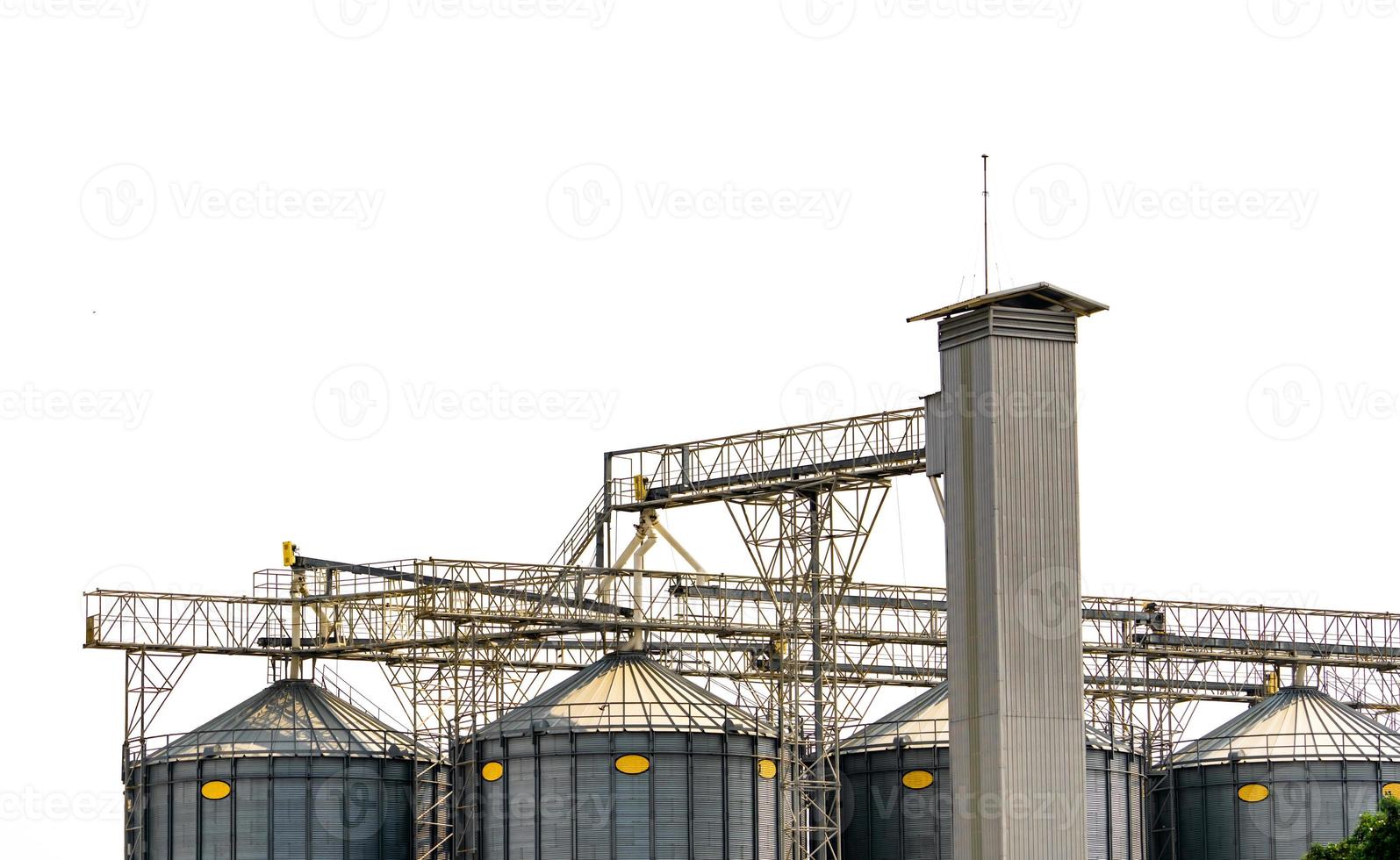 Agricultural silo at feed mill factory. Flat silo for store and drying grain, wheat, corn at farm. Storage of agricultural product. Big tank for store grain. Grain stock tower. Agriculture industry. photo