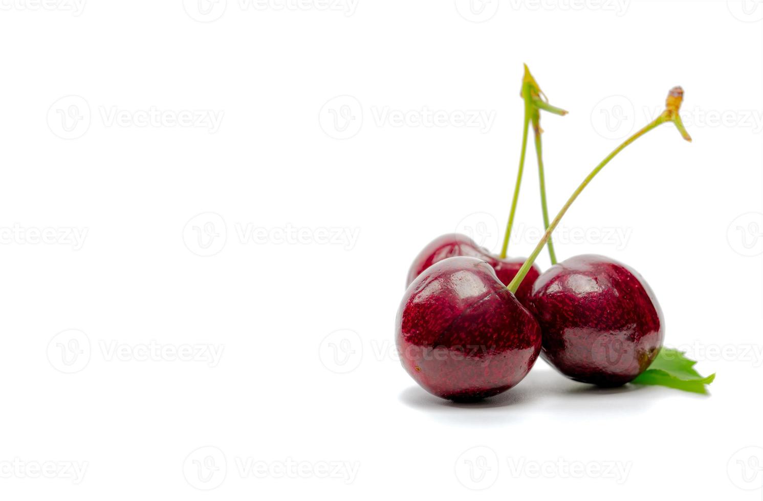 Red cherry with stalk and leaf isolated on white background. Ripe red sweet cherry. Sweet and juicy organic cherry. Fresh fruit for summer dessert. Raw material for jam industry. Antioxidant food. photo