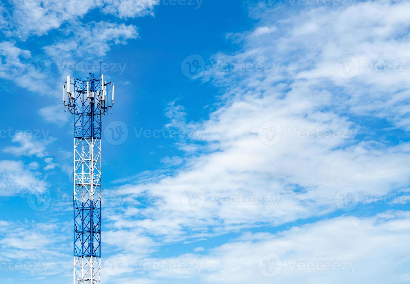 Telecommunication tower with blue sky and white clouds background. Antenna on blue sky. Radio and satellite pole. Communication technology. Telecommunication industry. Mobile or telecom 4g network. photo