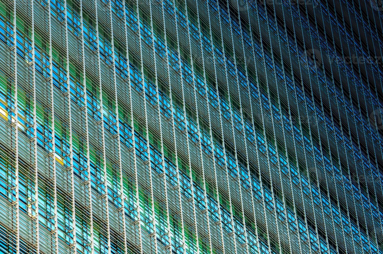 Modern futuristic glass building abstract background. Exterior of office glass building architecture. Facade of sustainable business building. Energy saving architecture. Glass window of company. photo