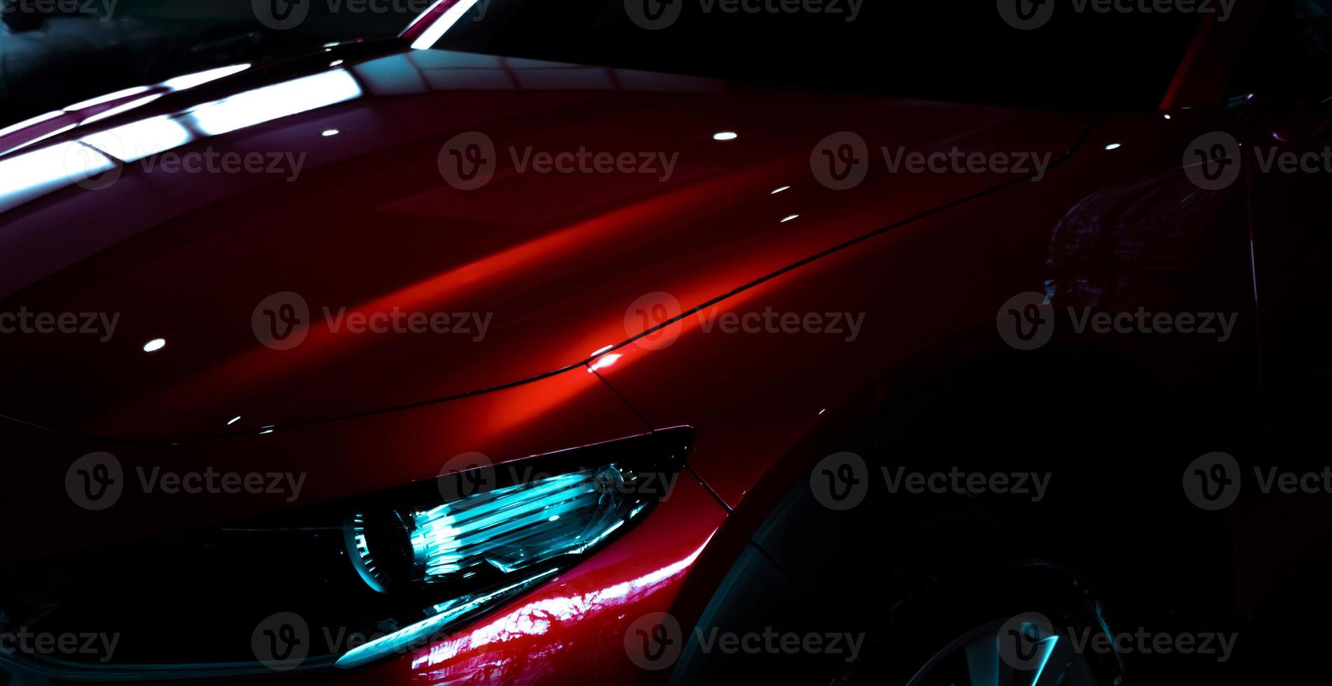 Selective focus on shiny red luxury SUV car in showroom. Elegant electric car with sport design. Car parked in showroom. Car dealership. Electric vehicle development concept. Future transportation. photo