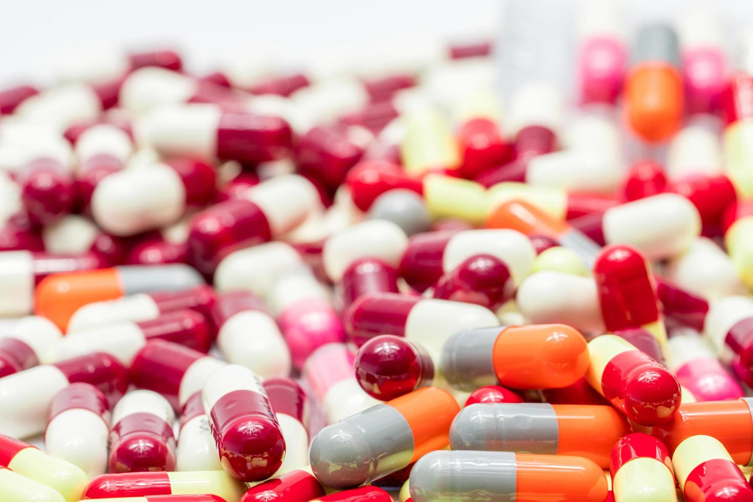 Selective focus on antibiotic capsule pills on blurred background of capsules. Pharmaceutical industry. Drug production. Global healthcare. Drug interaction. Antibiotic drug resistance and overuse. photo