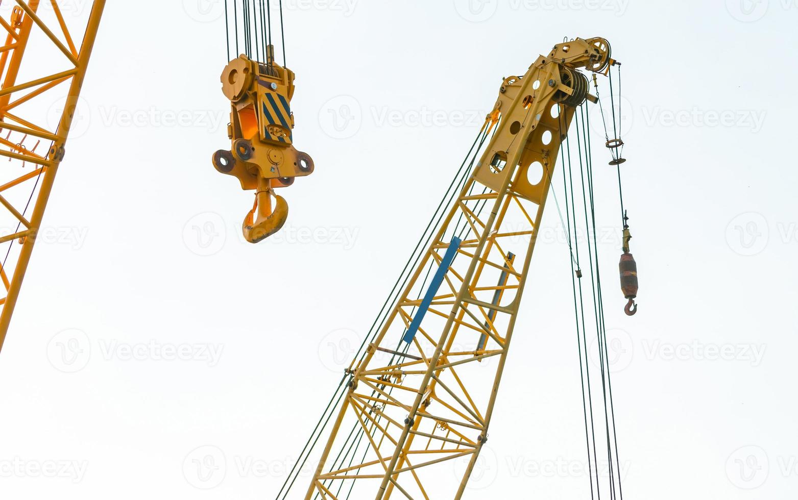 Crawler crane isolated on white background. Real estate industry. Yellow crawler crane use reel lift up equipment in construction site. Crane for rent. Crane dealership for construction business. photo