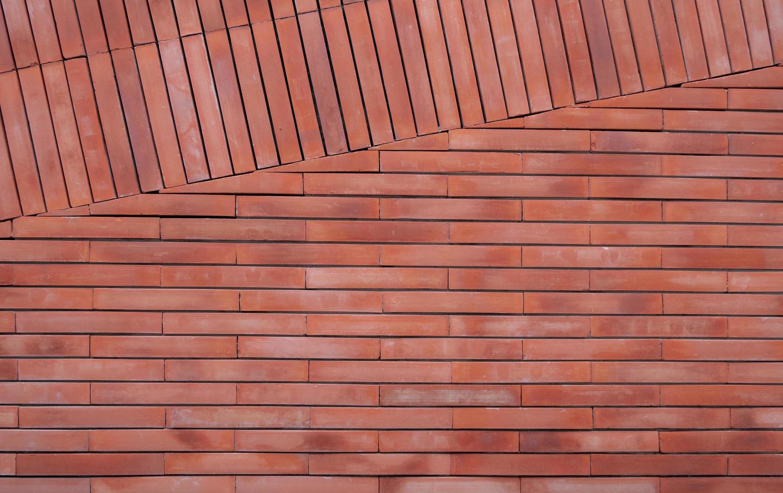 Orange brick wall texture background. Orange vintage pattern wallpaper. Empty brick wall. Orange shade brickwall background. Home wall interior design. Red wall of house. Light orange color brick. photo
