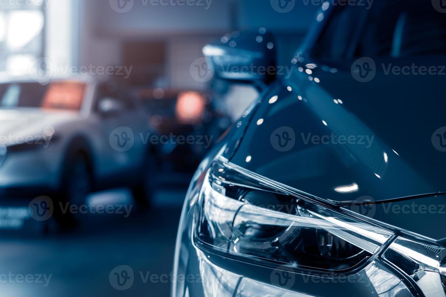 Selective focus grey car parked in luxury showroom. Car dealership office. New car parked in modern showroom. Car for sale and rent business concept. Automobile leasing and insurance background. photo