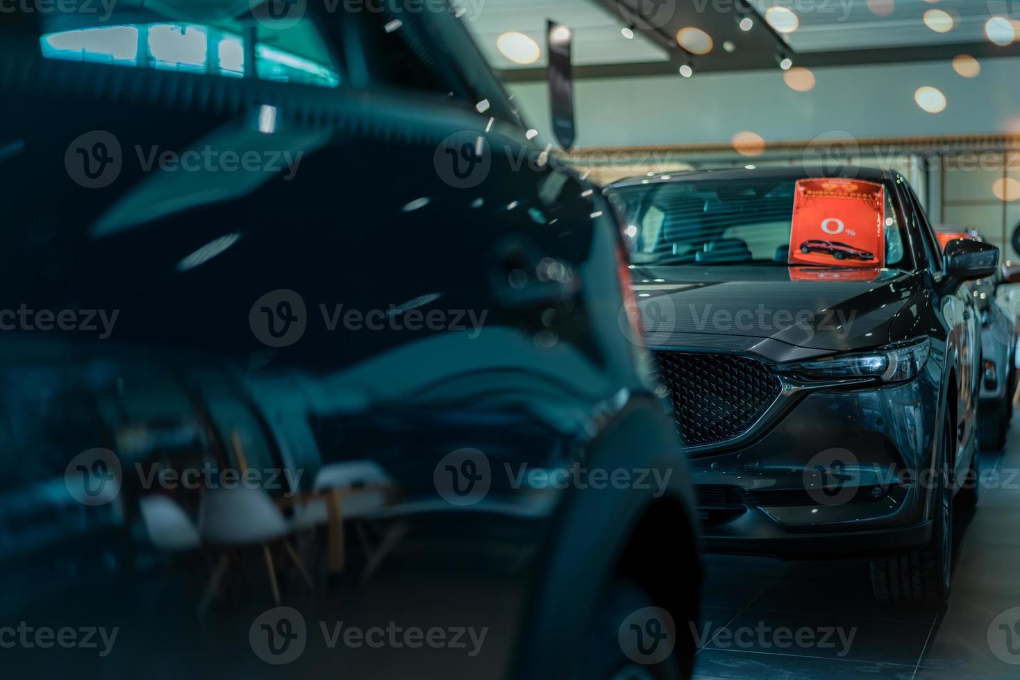 Selective focus luxury SUV car parked in luxury showroom. Car dealership office. New car parked in modern showroom. Car for sale and rent business concept. Automobile leasing and insurance background. photo