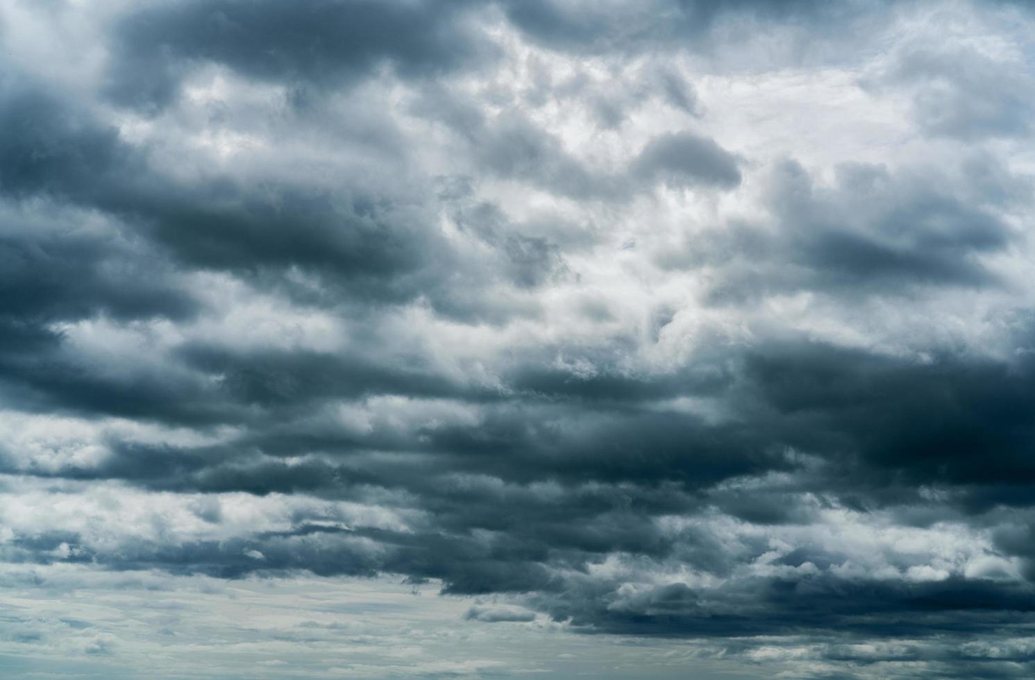 Dark dramatic sky and clouds. Background for death and sad concept. Gray sky and fluffy white clouds. Thunder and storm sky. Sad and moody sky. Nature background. Dead abstract background. Cloudscape. photo