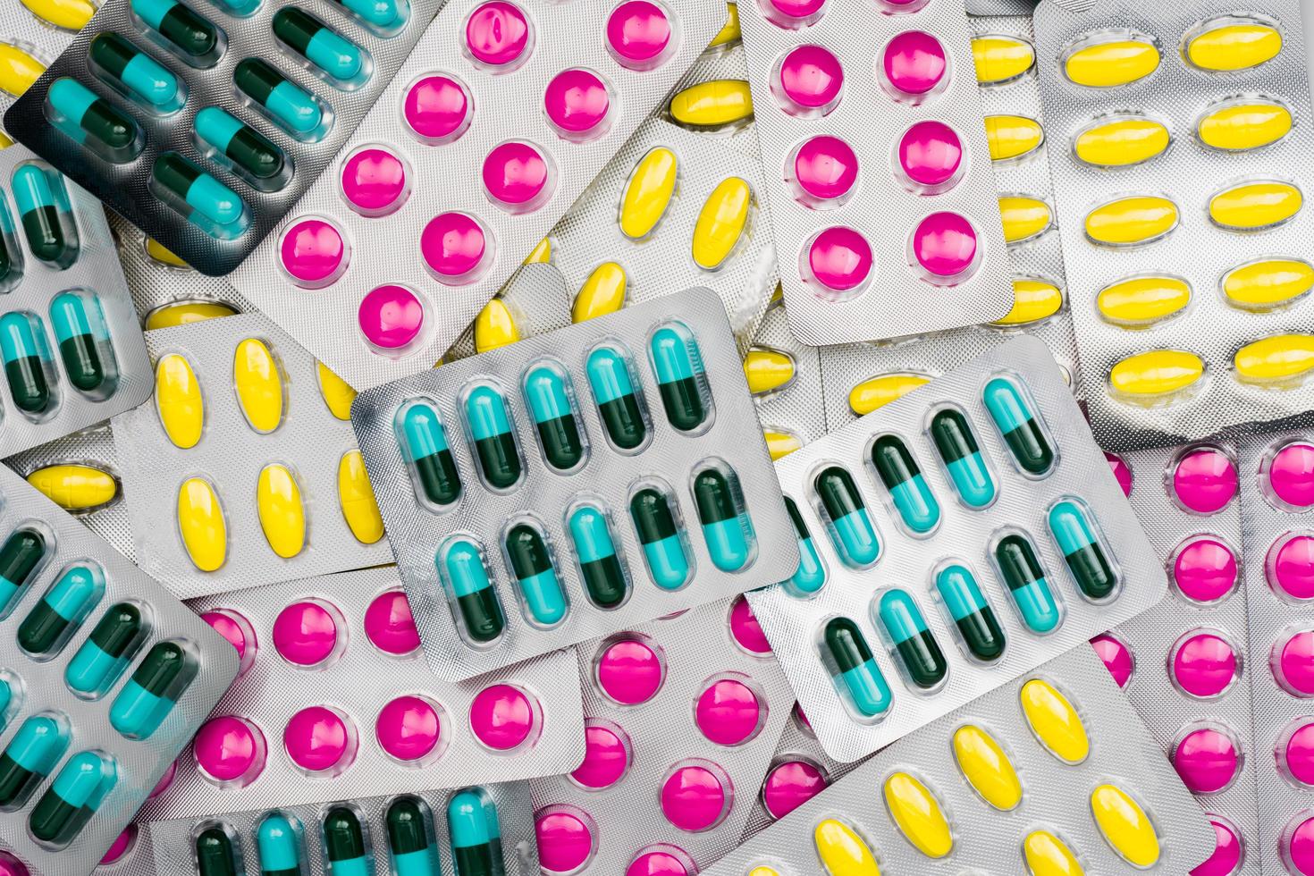 Top view of colorful pile of pills in blister packs. Drug use with reasonable concept. Global healthcare wallpaper. photo