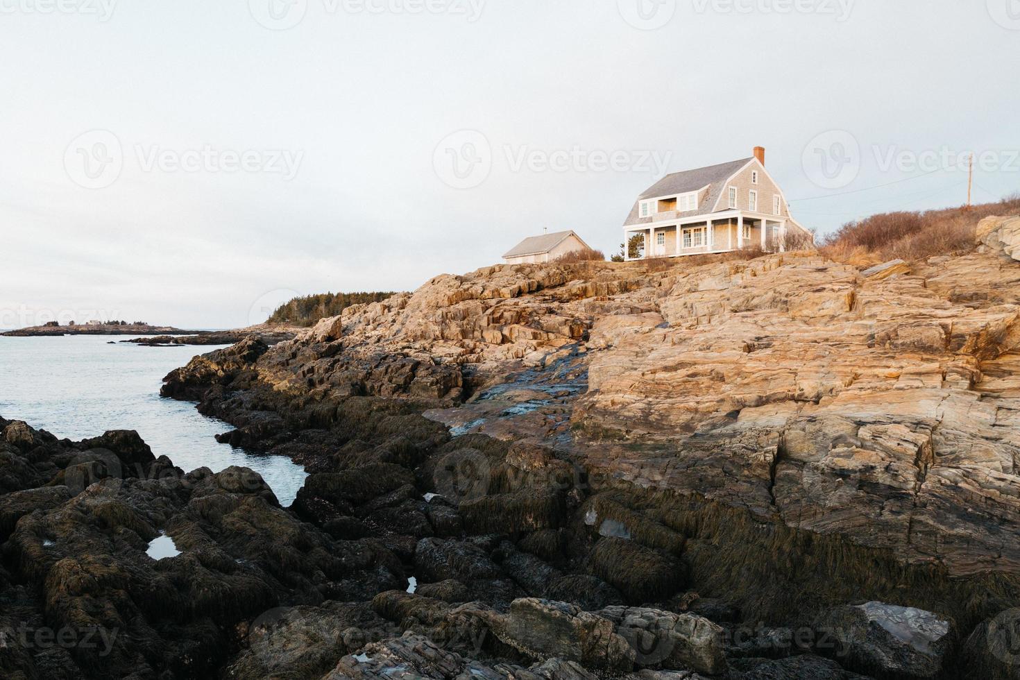 House by the ocean at golden hour photo