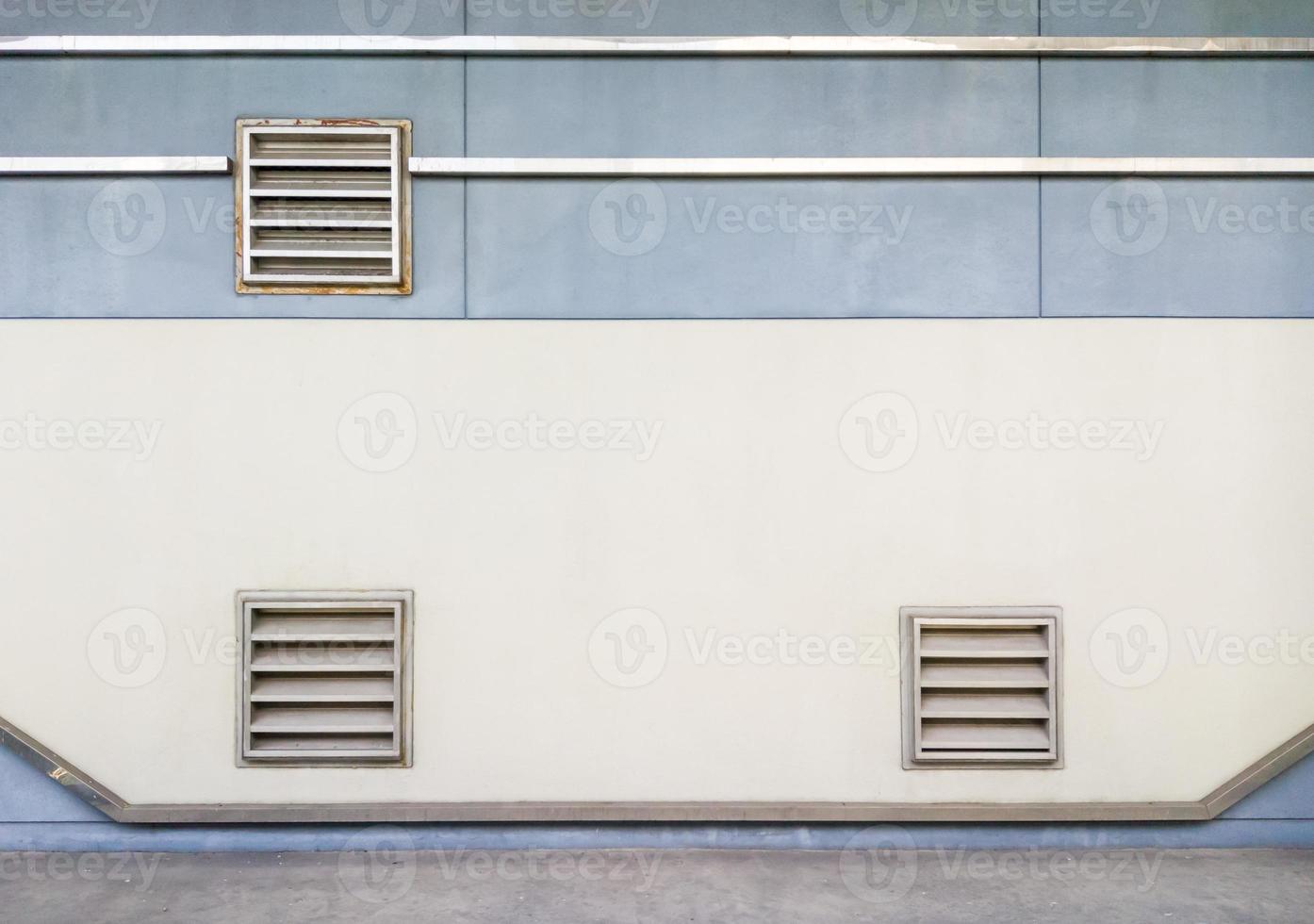 Metal grille of the ventilation system on the concrete wall. photo