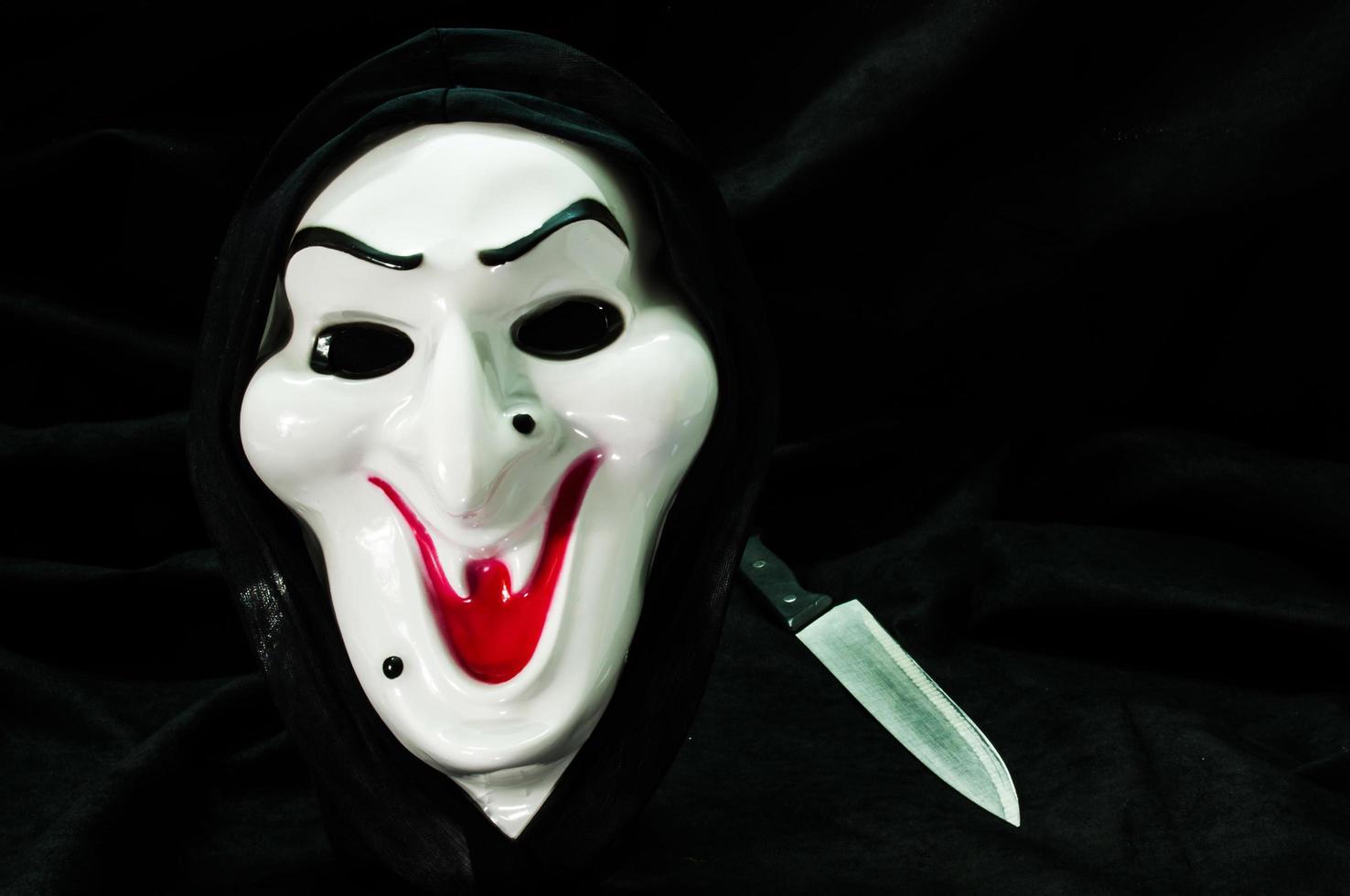 Halloween ghost face mask with knife photo