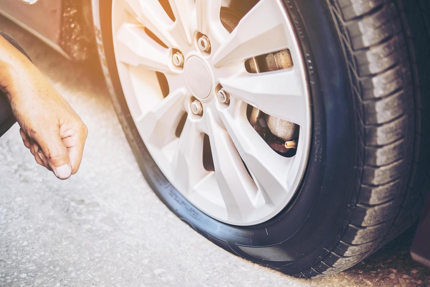 Technician is repairing car flat tire photo