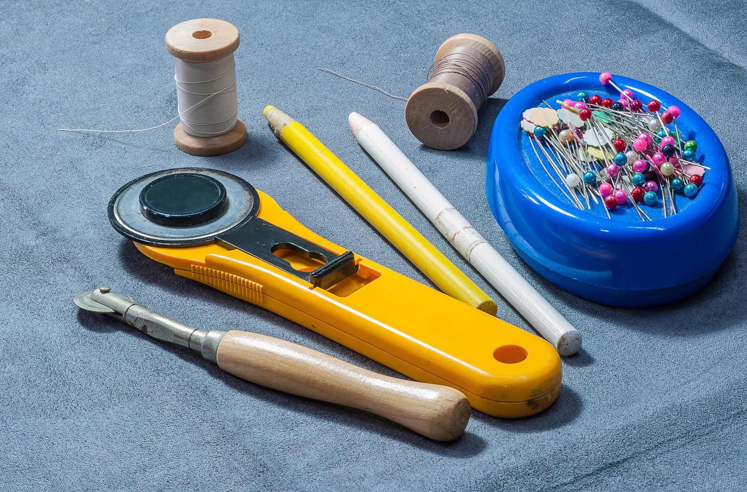 Patchwork sewing tools on gray cloth photo