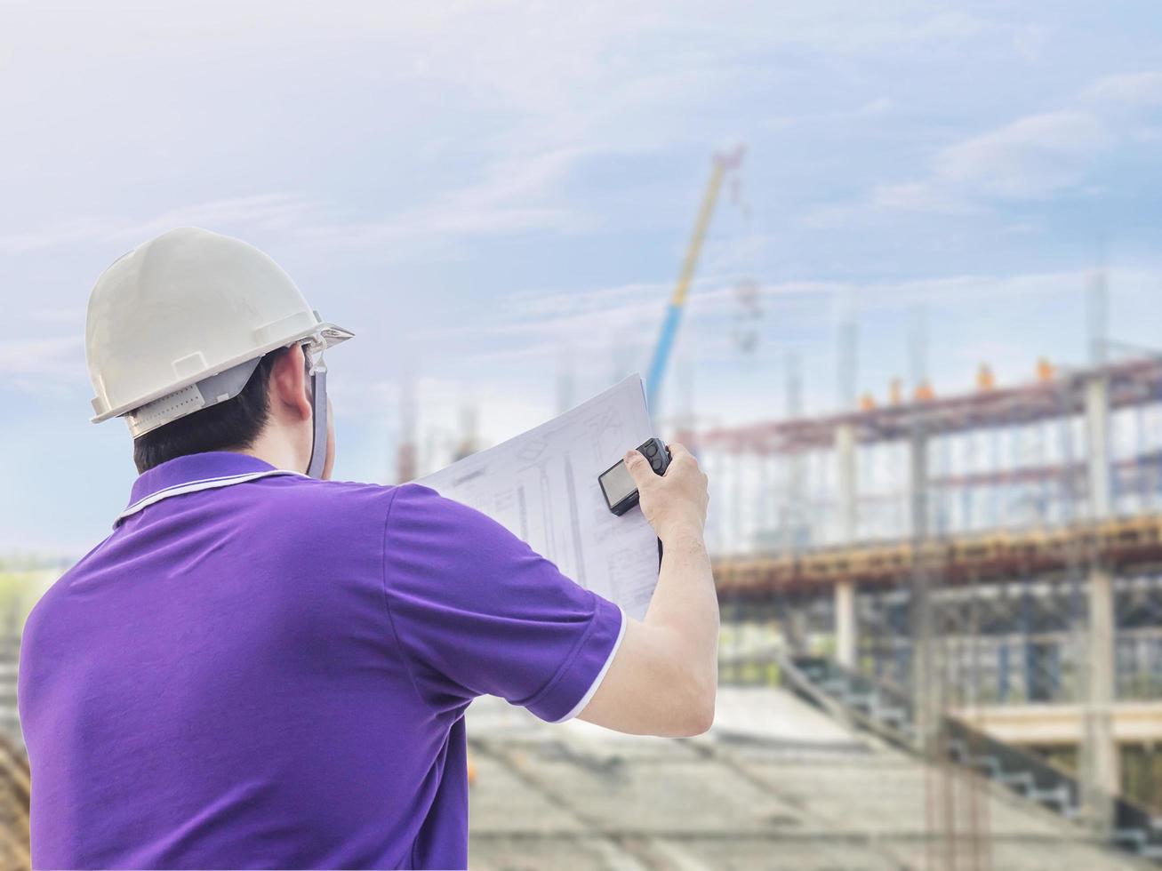 Engineer is inspecting his work in building construction site photo