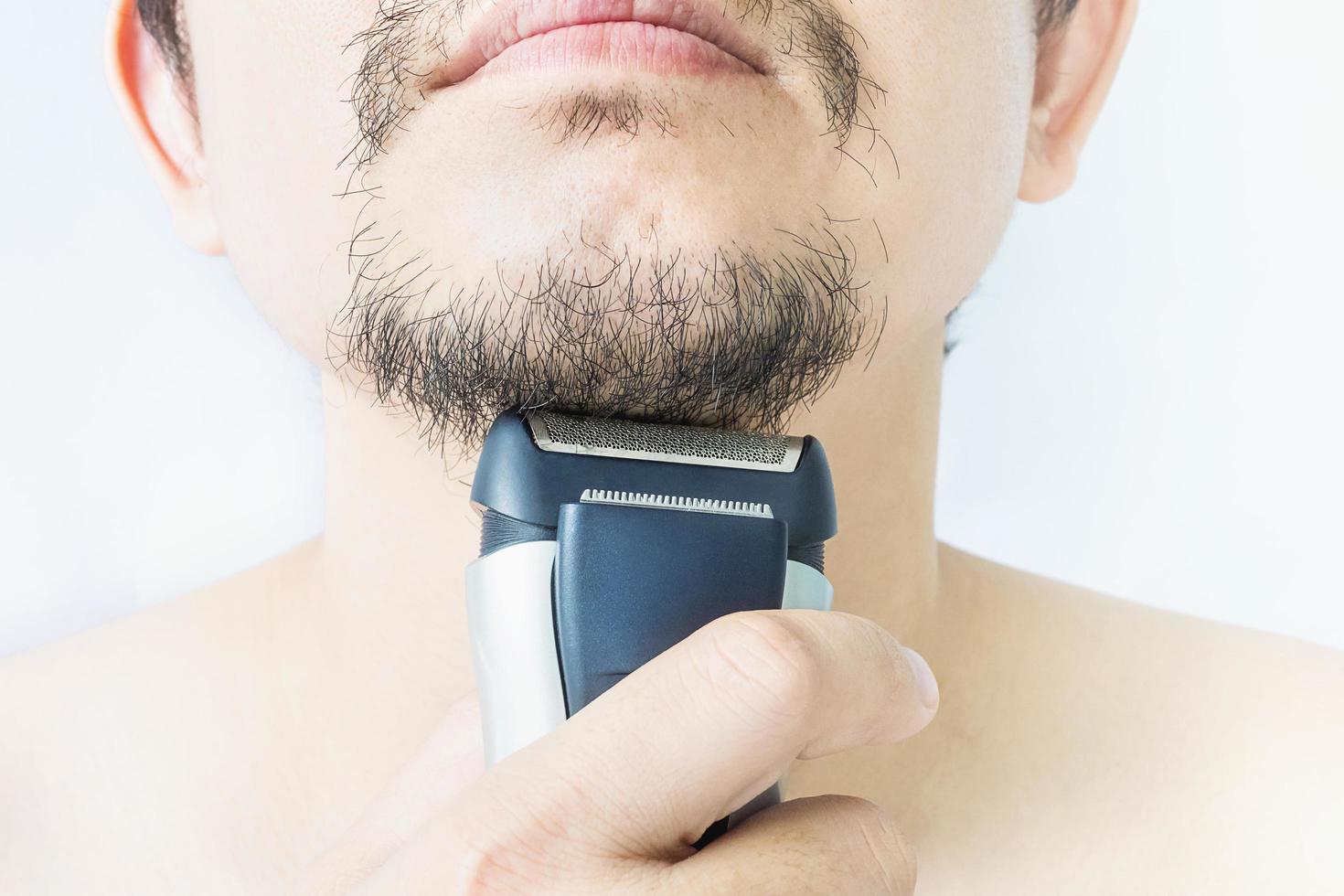 Man is using shaver photo