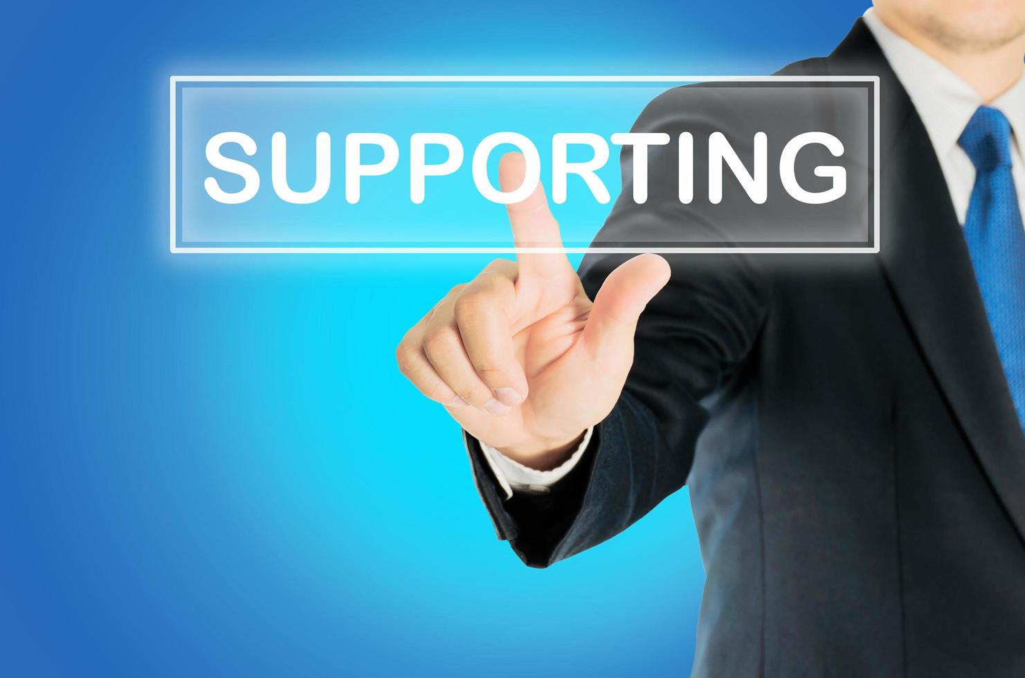 Business man is pushing SUPPORTING transparent button word over blue gradient background, business concept photo