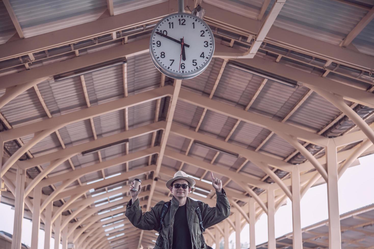Travel man is waiting train at train station, Chiangmai Thailand, 23 May 2019 photo