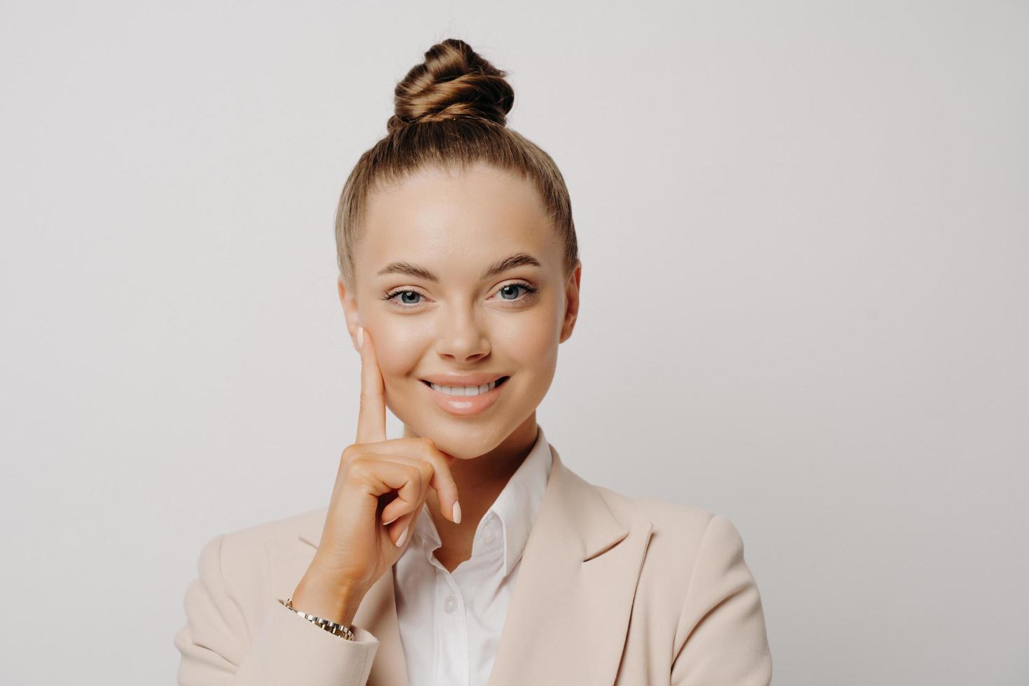 Office worker in beige suit feeling happy photo