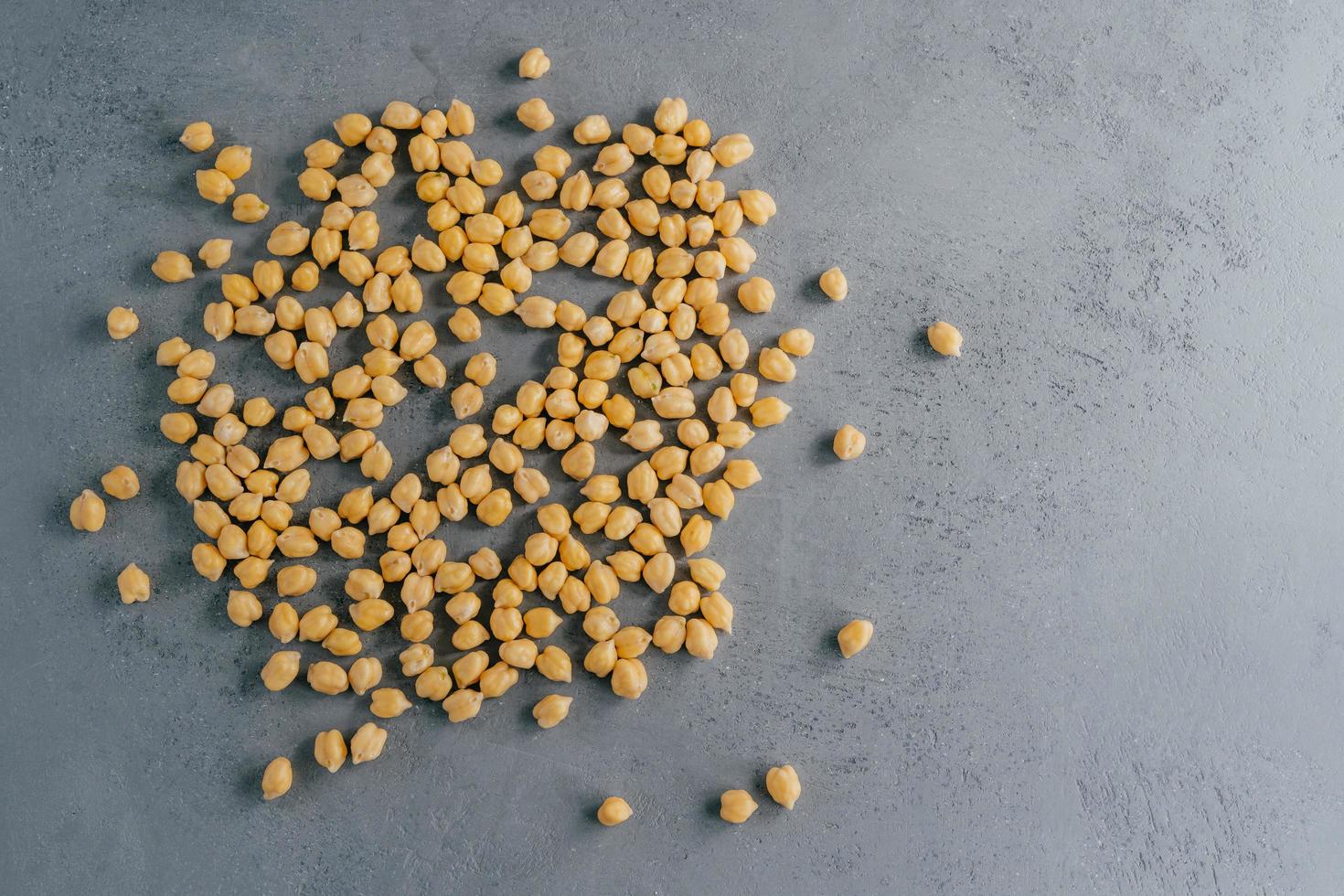 Top view of clean fresh garbanzo or chickpeas on grey background. Flat lay. Raw food for vegans. Close up. Ingredients full of protein photo