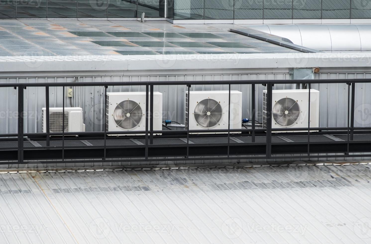 The compressor unit row of the air conditioner system on the top of the modern commercial building. photo