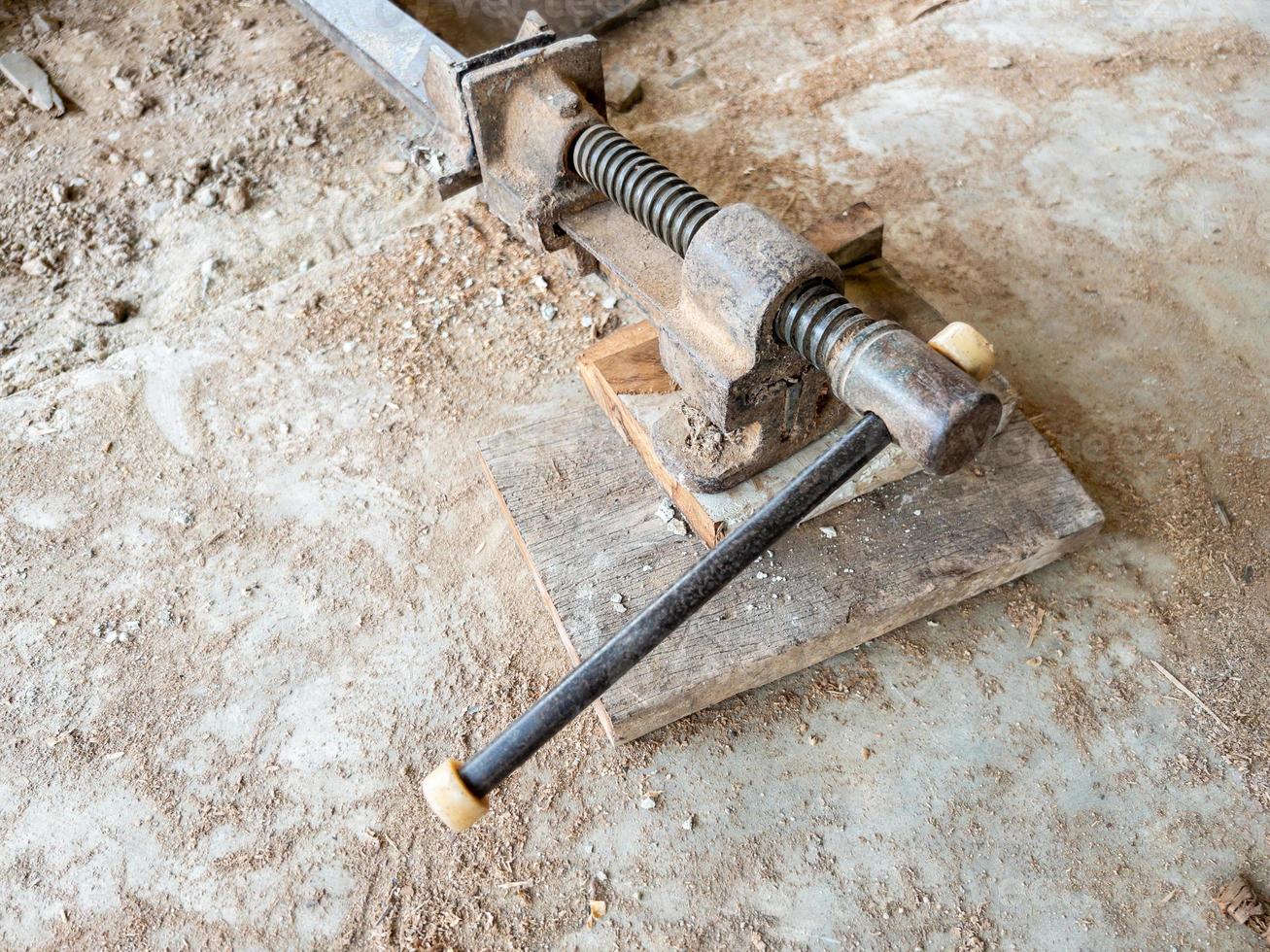 The old clamps tool on the dirty ground for use in the small site. photo