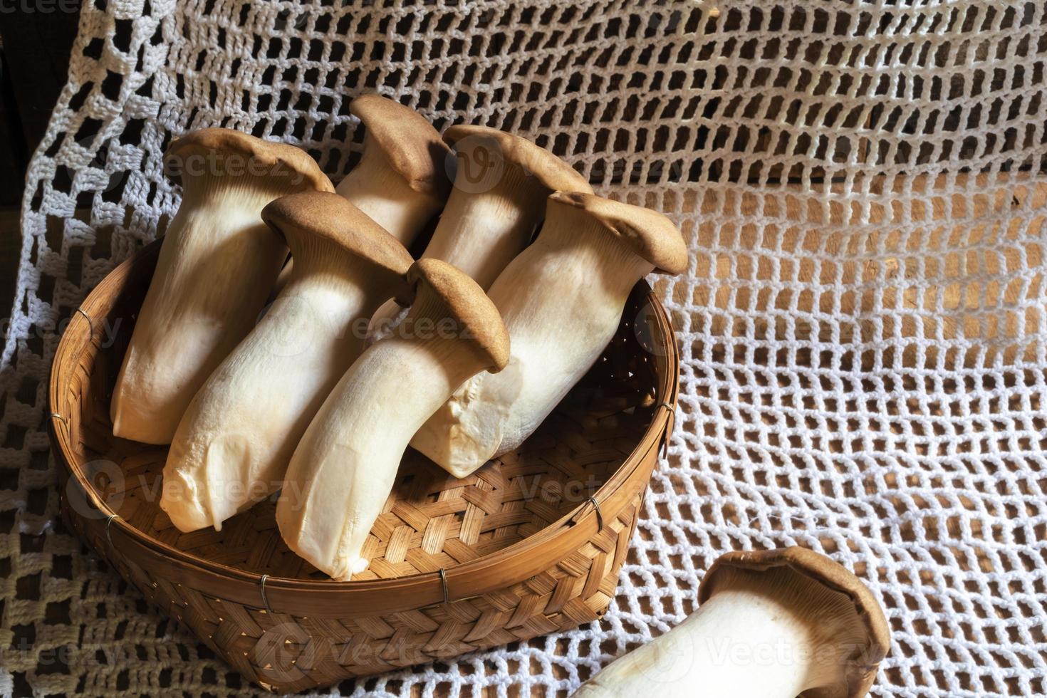 Healthy food king oyster mushroom in basket on wood background. photo