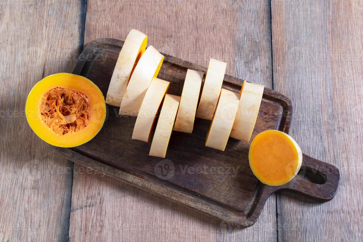 Healthy food butternut squash sliced isolated on wood background. photo