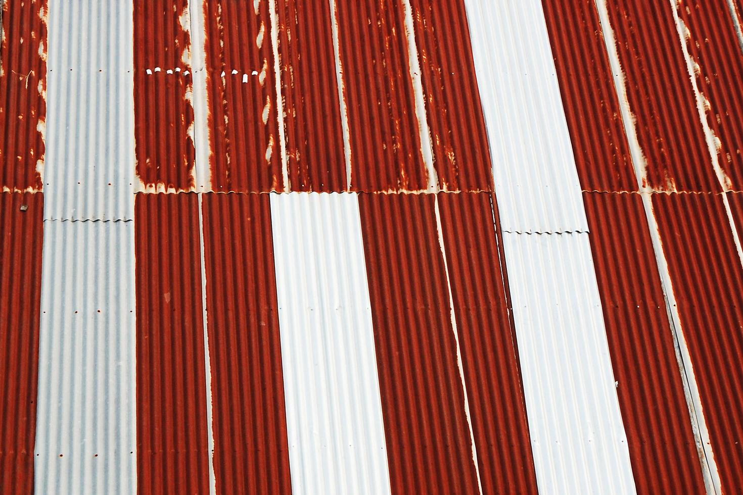 The old galvanized roofs that were thin, rusted, were red, alternating with gray with curls or wavy to allow water to flow. photo