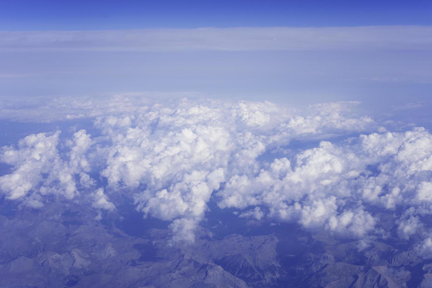 Clouds and mountains, view from an airplane photo