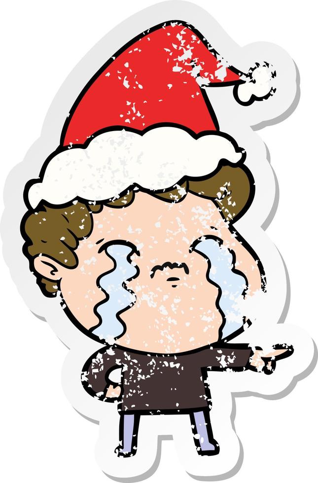 distressed sticker cartoon of a man crying wearing santa hat vector