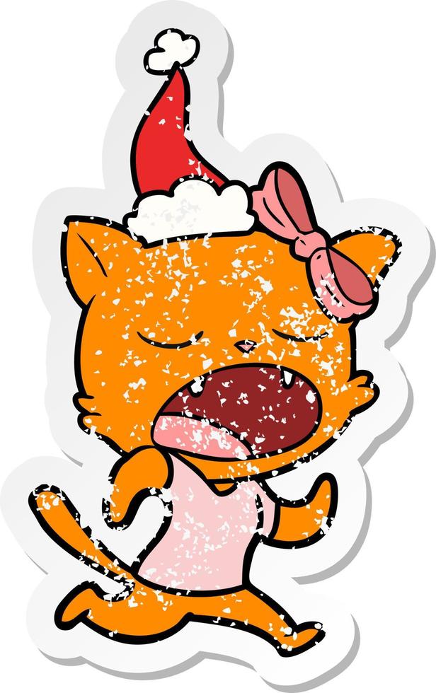 distressed sticker cartoon of a yawning cat wearing santa hat vector