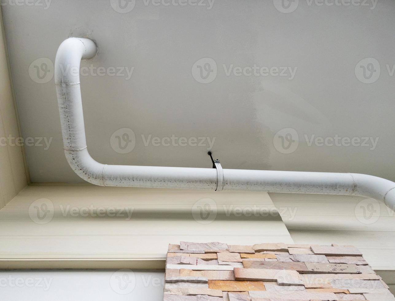 The white curve pipe for drainage of the air conditioner system photo