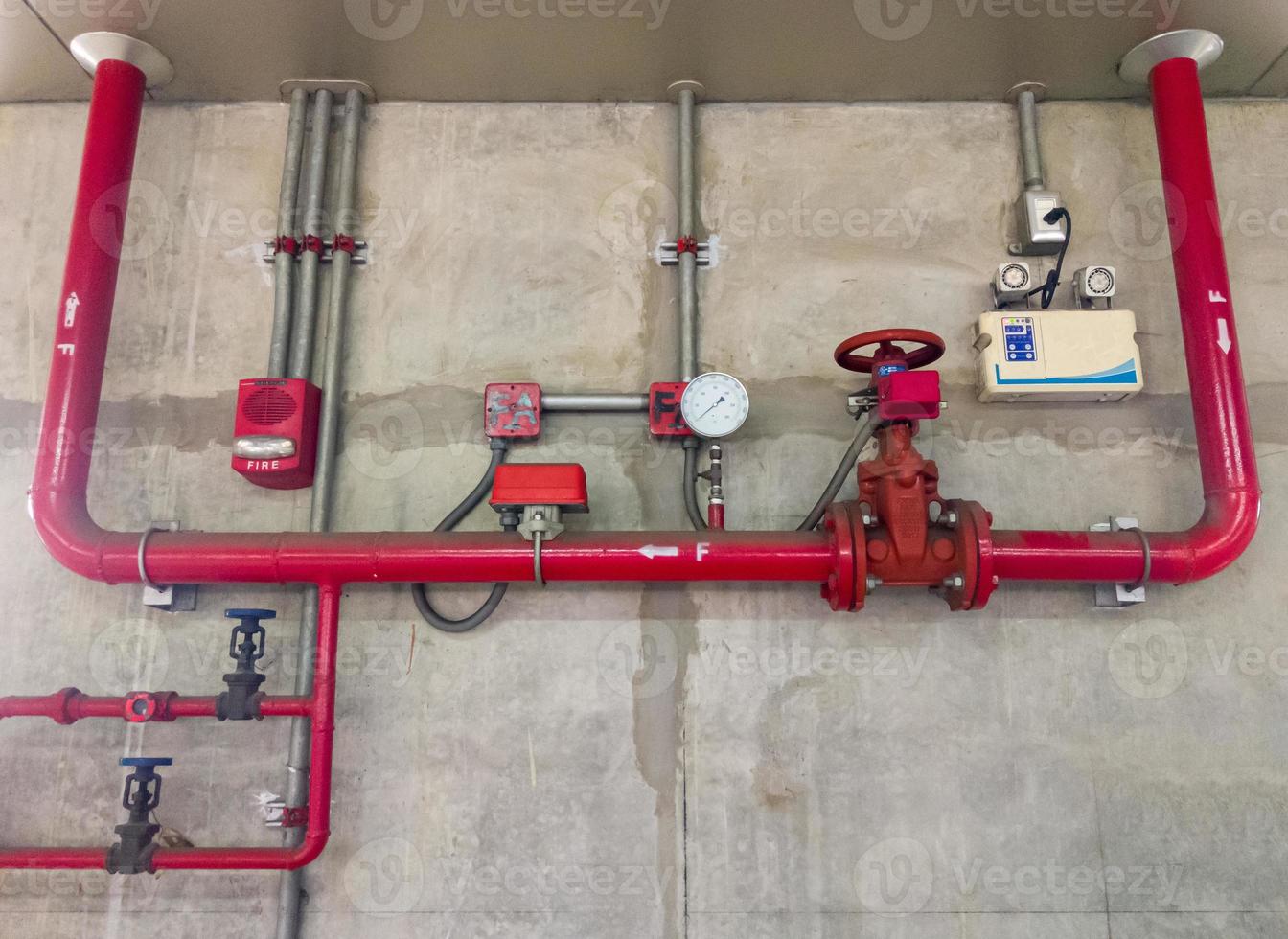 The red metal pipe and large valve of the fire fighting system photo