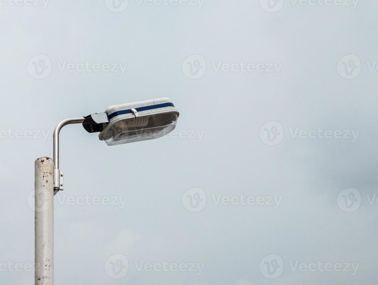 Electrical lamp on the metal pole. photo