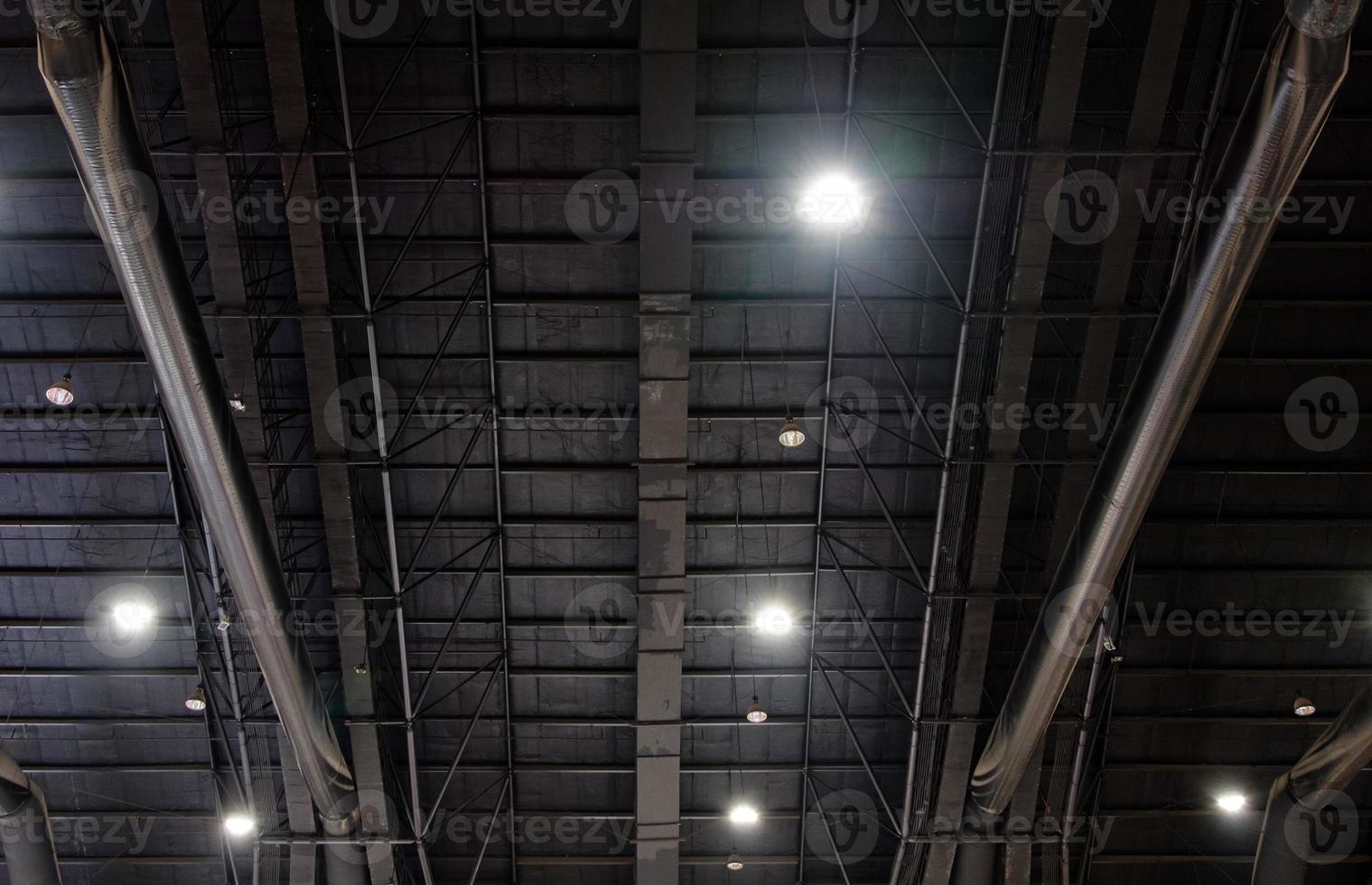 The truss metal frame with the electric bulb system on the ceiling. photo