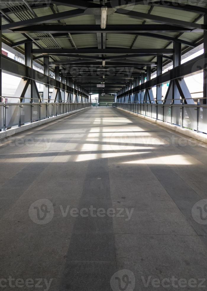 Lonely walkway of the metal frame bridge. photo