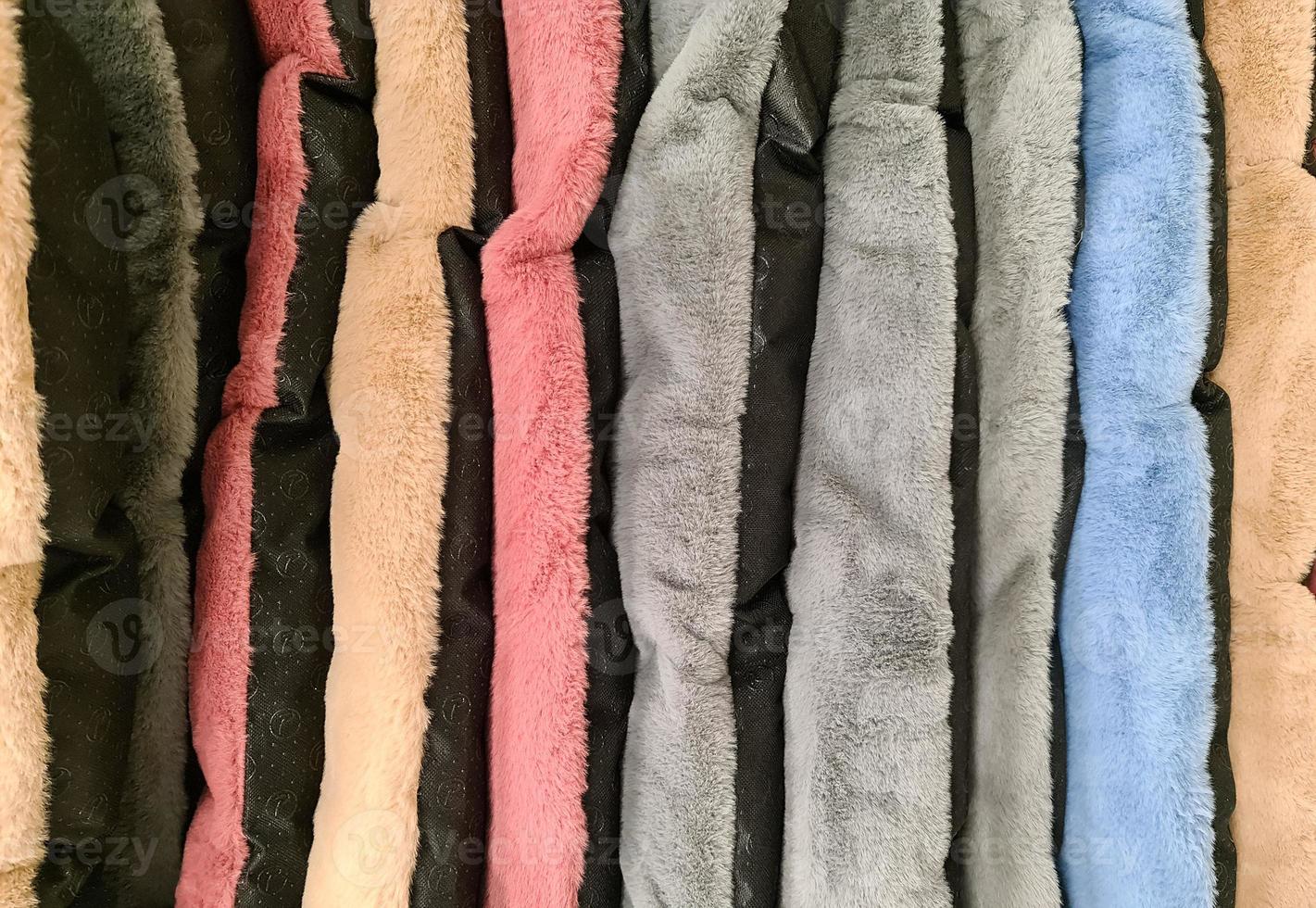 Detailed close up view on samples of cloth and fabrics in different colors found at a fabrics market photo