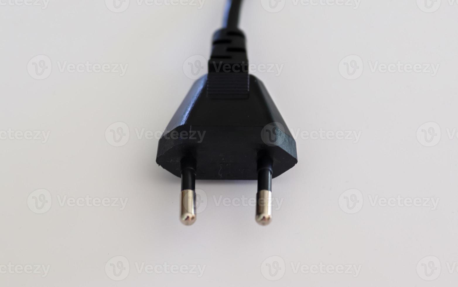 Isolated electrical black and white european plugs on a white background photo