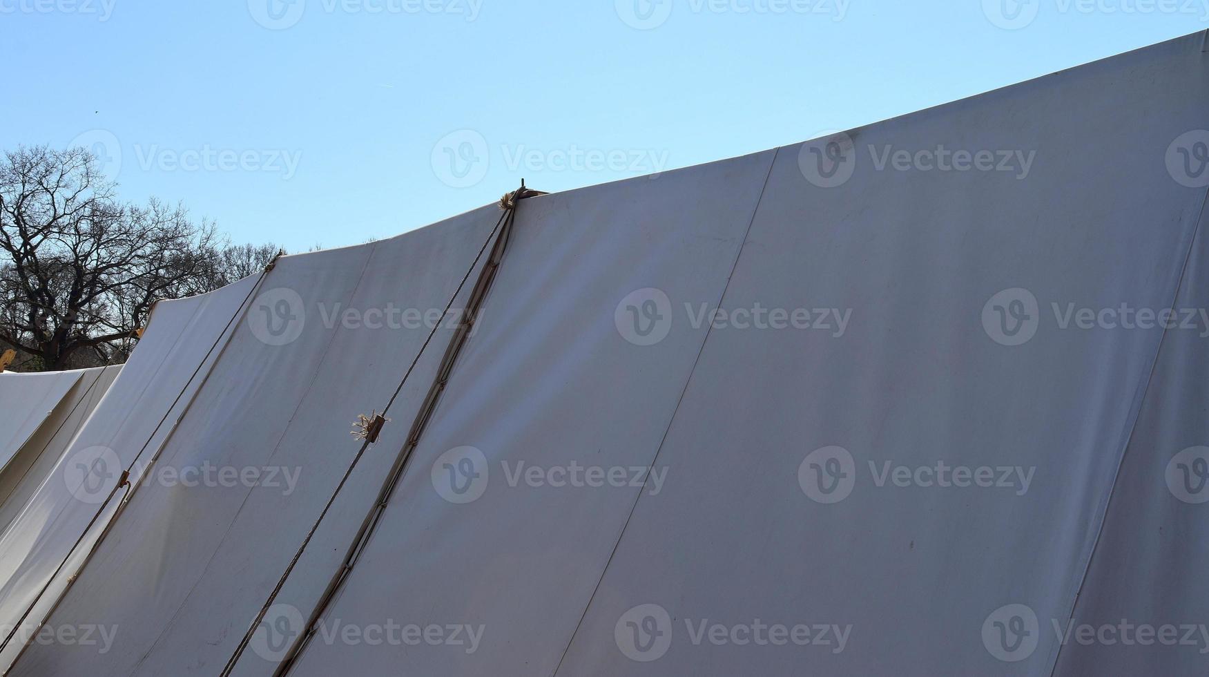 Old vikings tent made of wood and cloth in front of a blue sky photo
