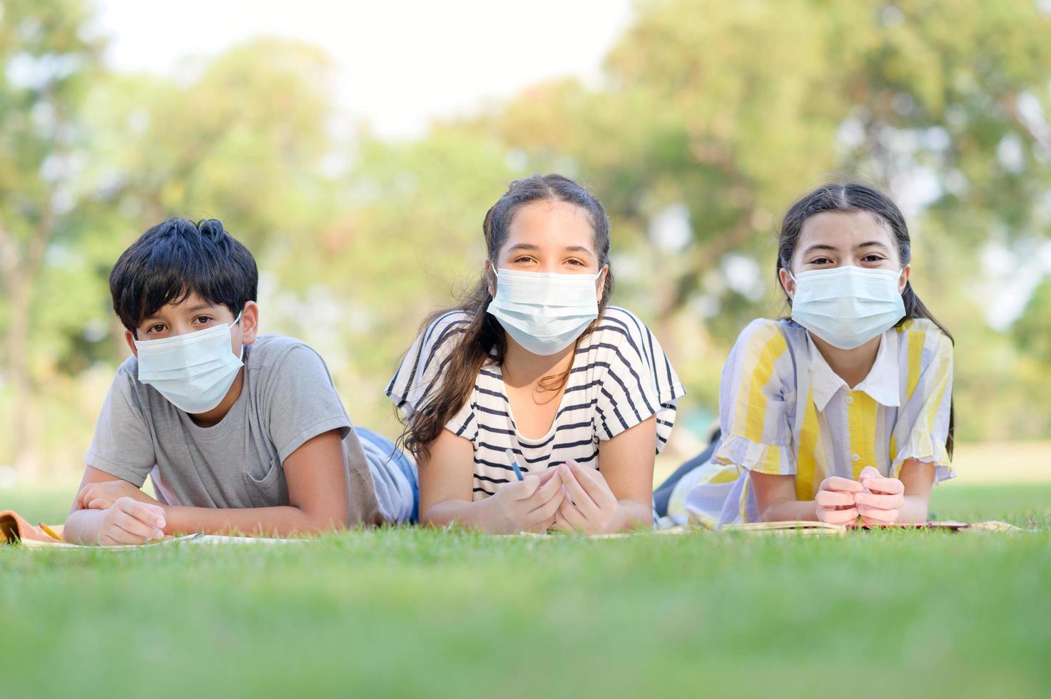 A half-Thai-Indian boy and a mixed-Thai-European girl friend wear face masks to prevent virus photo