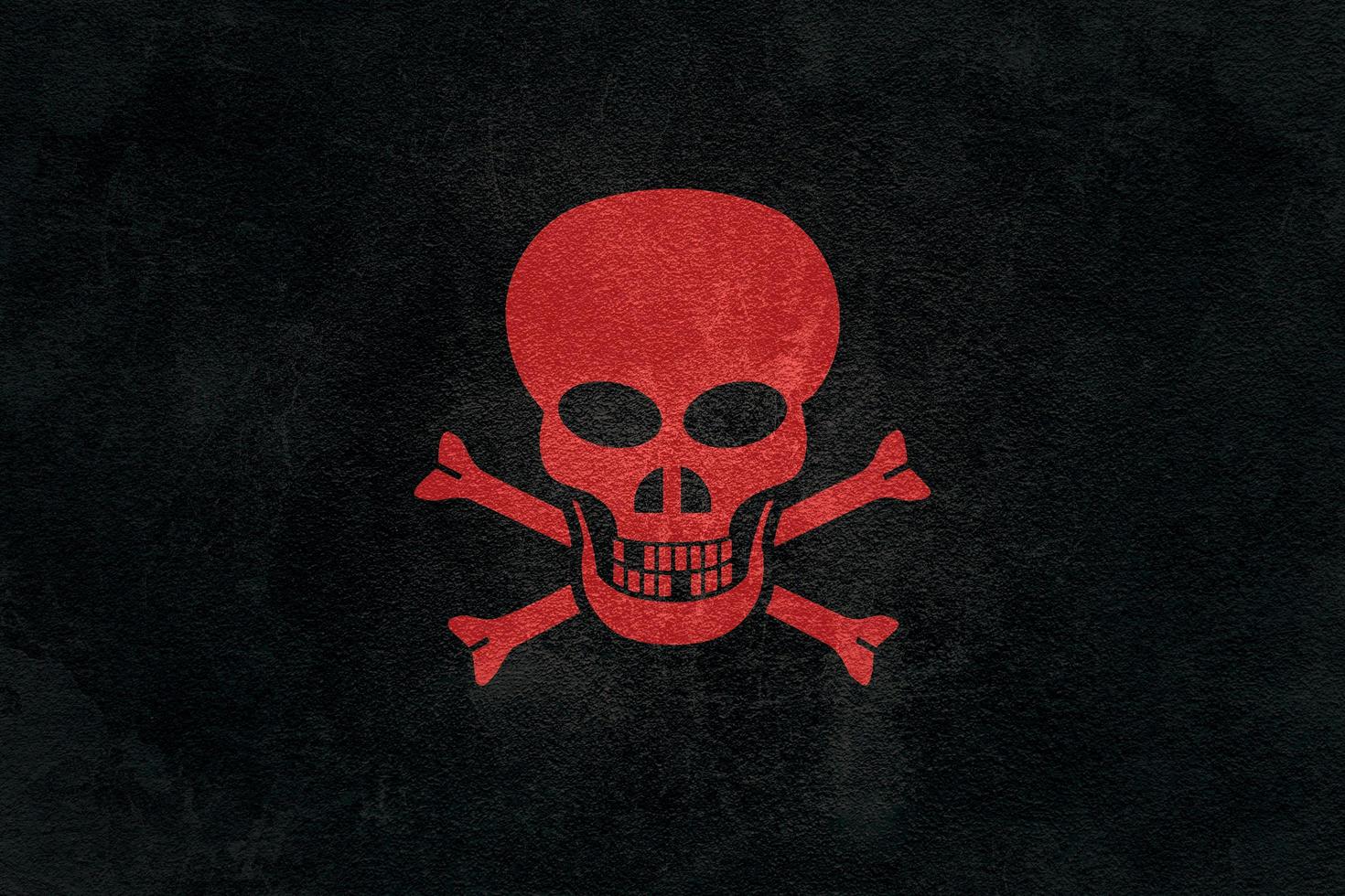 Illustration depicting a red skull on a black asphalt background photo