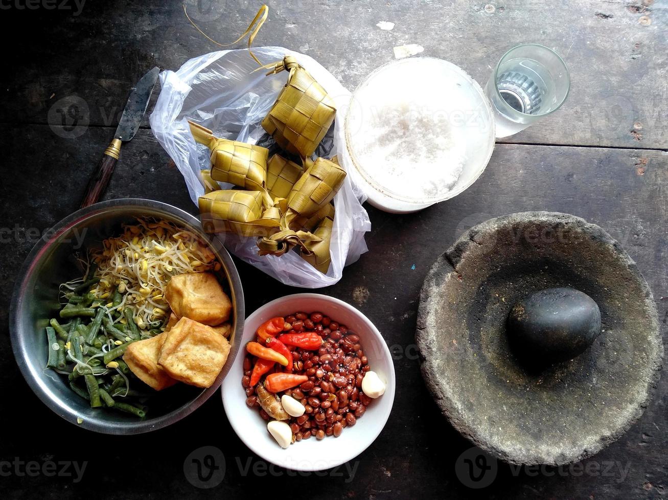 Ketupat, Toge, peanuts, Cobek stone, tofu and others. Indonesian culinary food photo